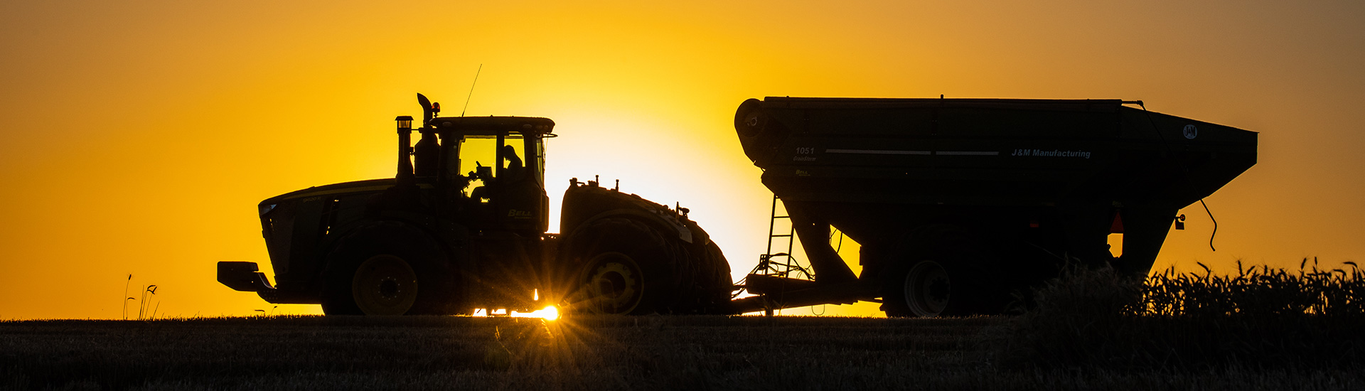 Sunset with tractor and gravity box